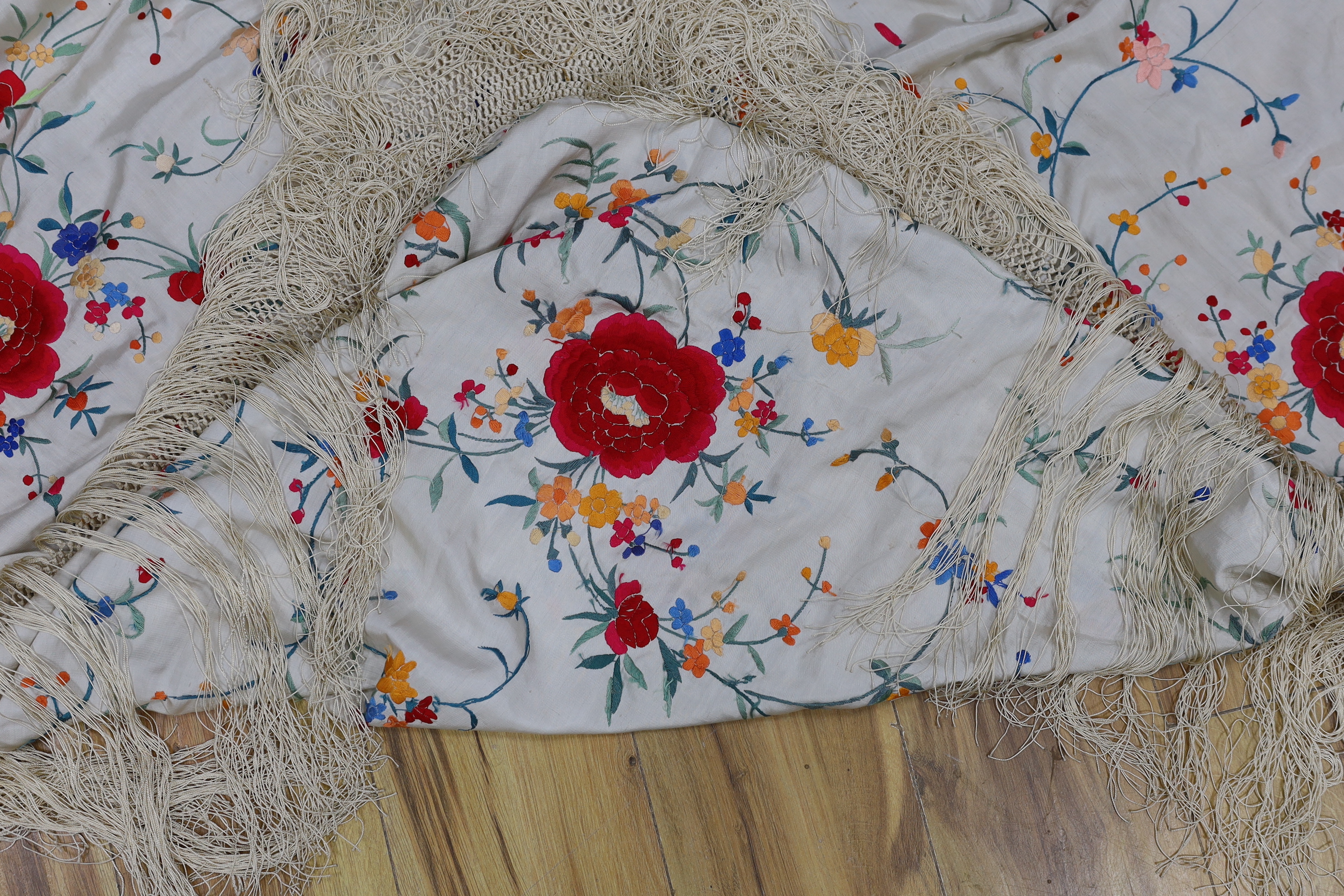 A Chinese cream silk polychrome embroidered shawl